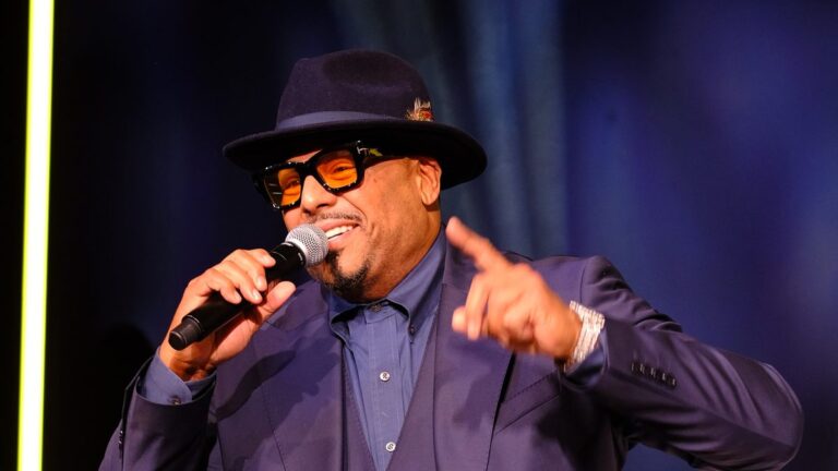 Al B. Sure! singing into a microphone on stage in 2025