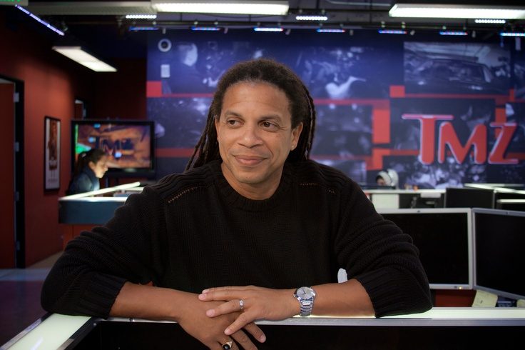 Charles Latibeaudiere leaning on a desk in the TMZ newsroom in Los Angeles
