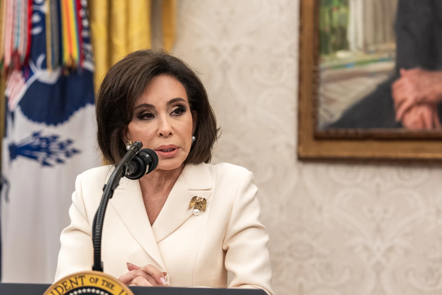 Jeanine Pirro speaking at a podium in the Oval Office after being sworn in as interim U.S. Attorney for the District of Columbia in May 2025